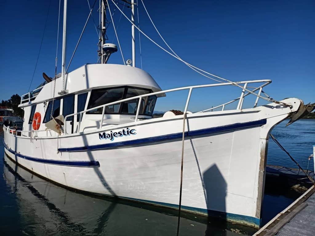 Majestic seen at its mooring in Motueka Marina. The side of the boat is viewed in close up.