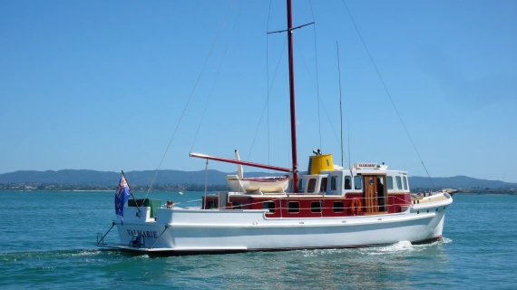 Valmarie boat steaming wit hills in the background