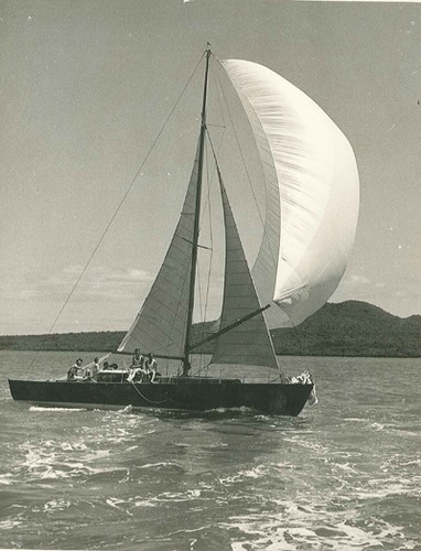 Black and white image of the Fiery Cross yacht sailing off Rangitoto Island