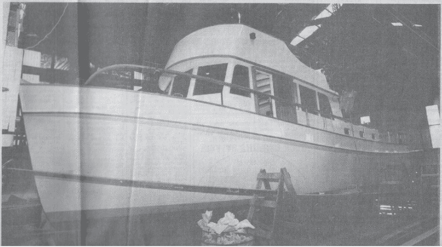 Black and white image of the boat Mermaid on the slip. The boat is viewed from the side and has plank scaffolding around her.