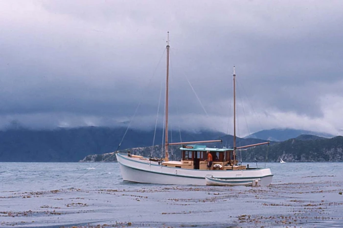 View of Hinewai from the side with a dinghy in front.