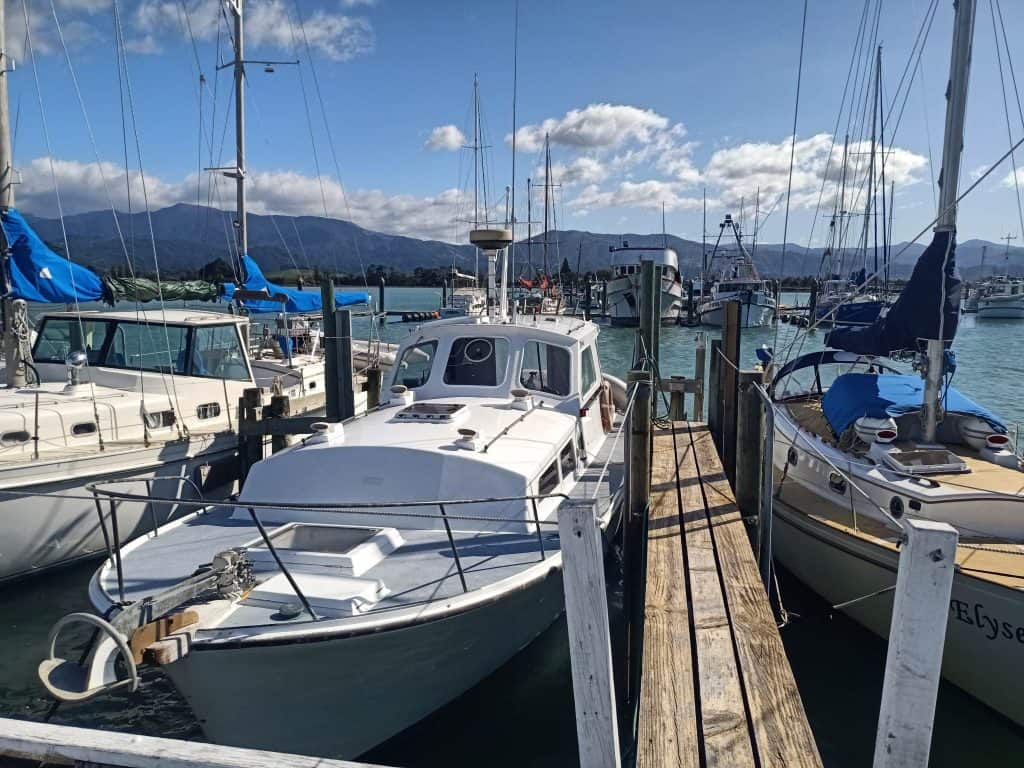 View of the boat Hine Moana II In Motueka marina. The boat is seen tied to its berth and seen from the front.