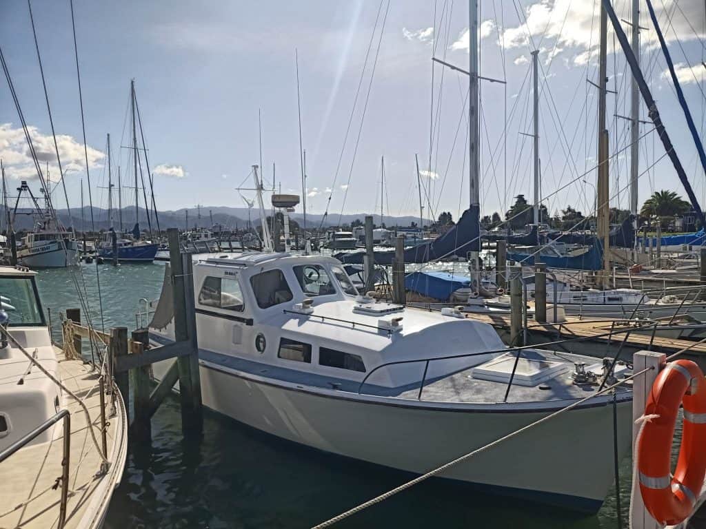 View of the boat Hine Moana II In Motueka marina. The boat is seen tied to its berth and seen from the side