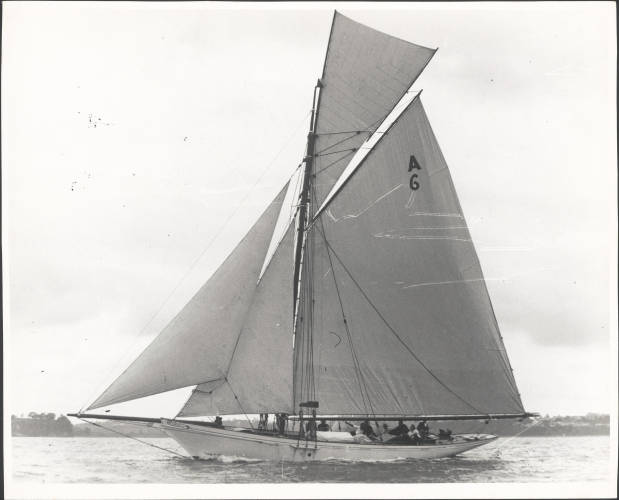 Black and white image of the yacht Waitangi with the sails up.