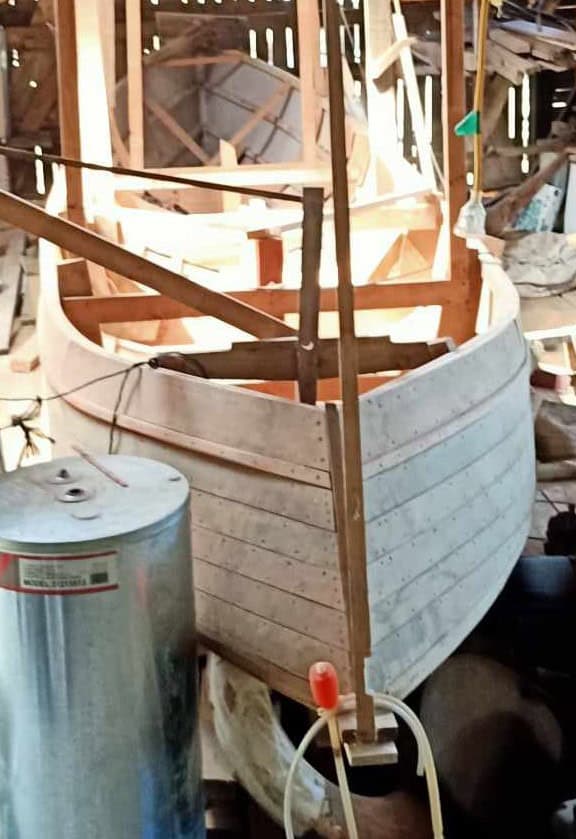View of the boat Tanekaha inside the boat shed at Wakatahuri. Looking at the bow.