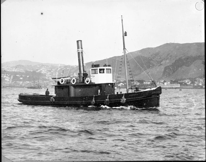 Black and white image of the boat Karaka taken from the side as she is traveling. Taken circa 1920s.