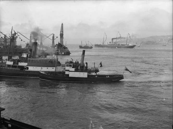 Black and white image looking down at several boats moored together waiting for the arrival of HMS New Zealand