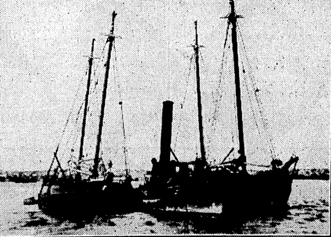 Black and white image of The Countess being raised out of the water by two boats either side of her.