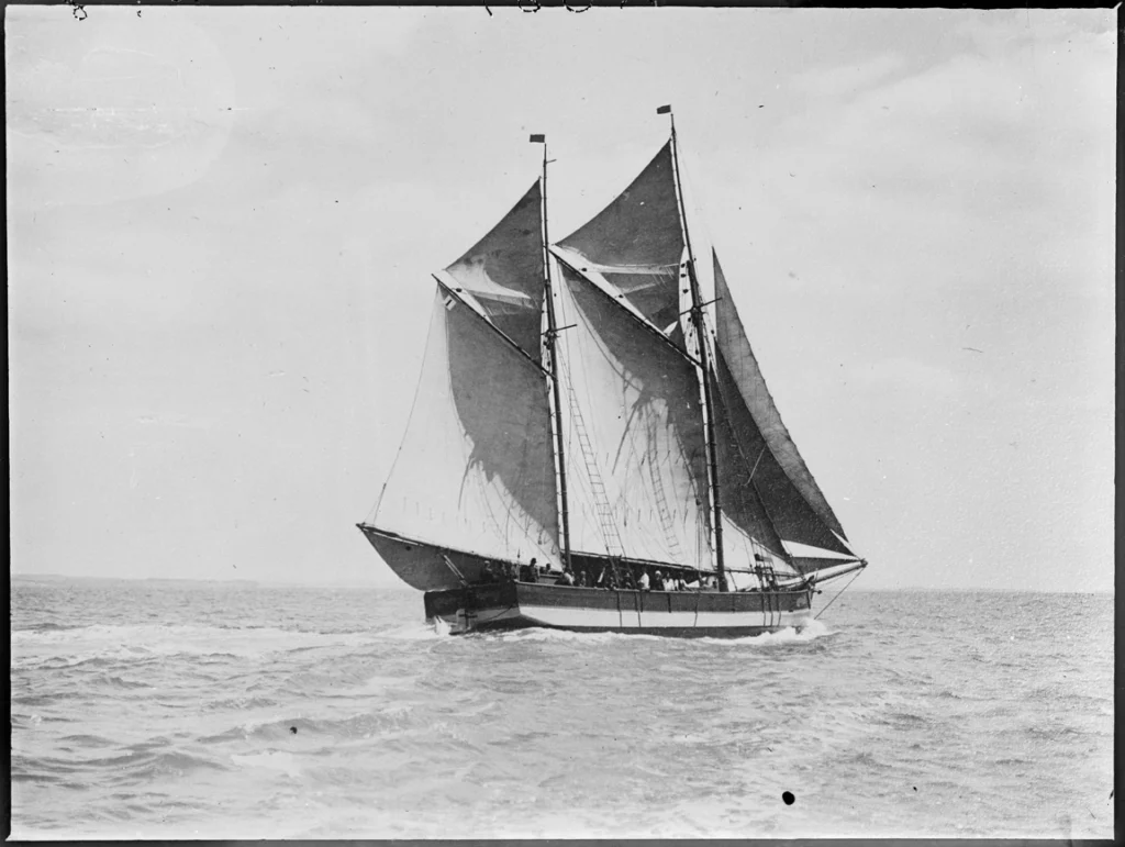 Black and white image of the scow Vixen under sail and heading away from the camera. The image was taken at the Auckland Anniversary Regatta...29 Jan 1917.